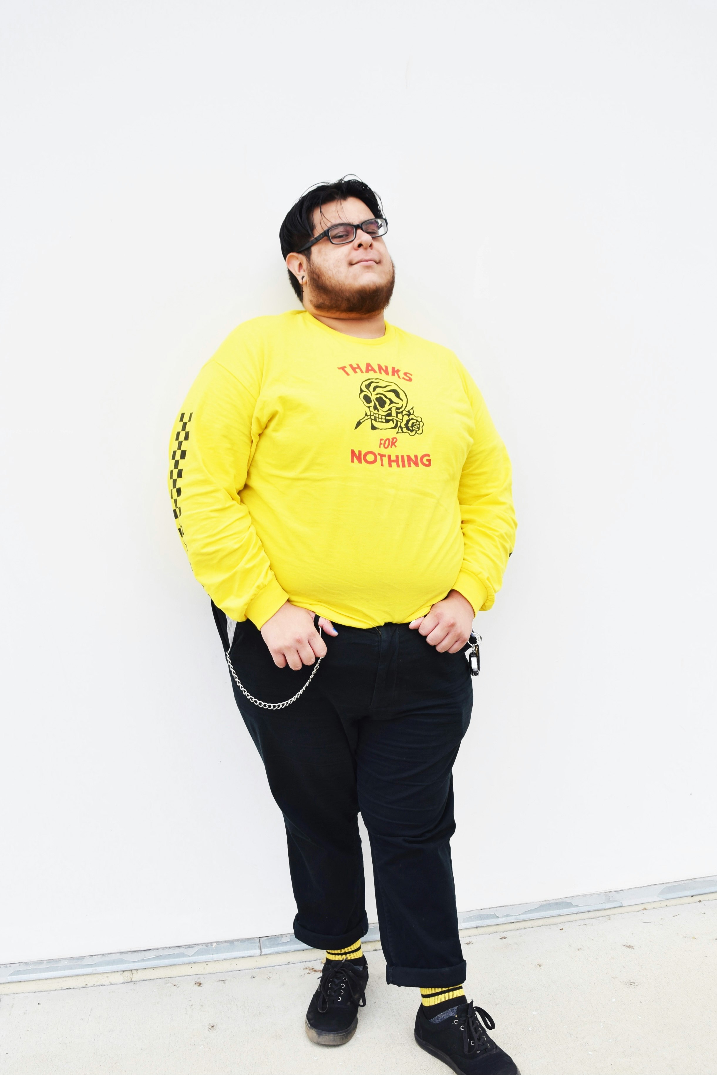 man in yellow crew neck long sleeve shirt and black pants